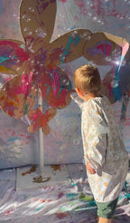 Kids wearing Blossom print art smock during messy play