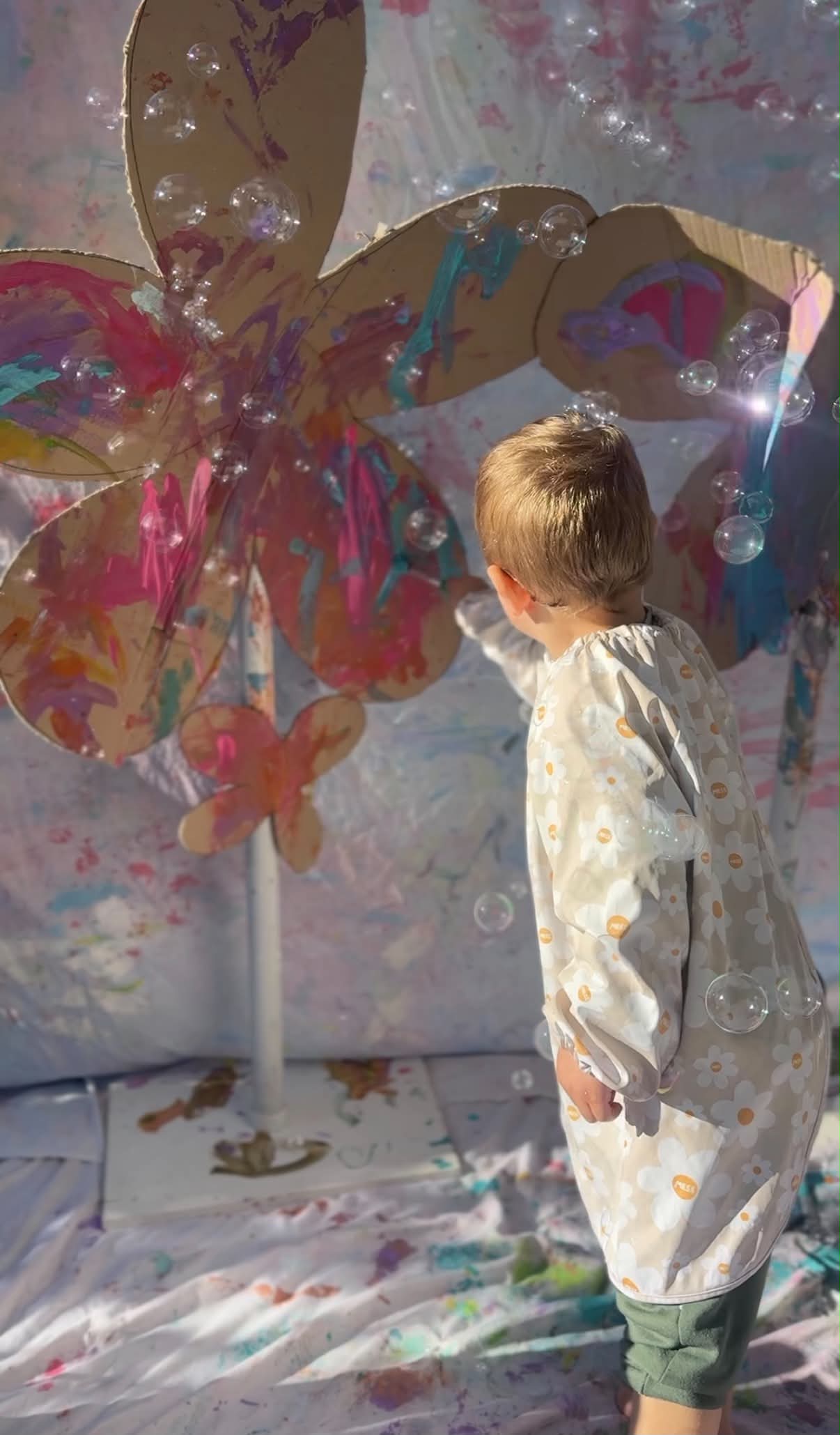 Kids wearing Blossom print art smock during messy play